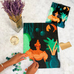Near-completed Reyna puzzle on marble table with glass of wine.