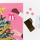 Near completed Puzzle with a tube of puzzle glue and straight-edge tool to spread the glue.