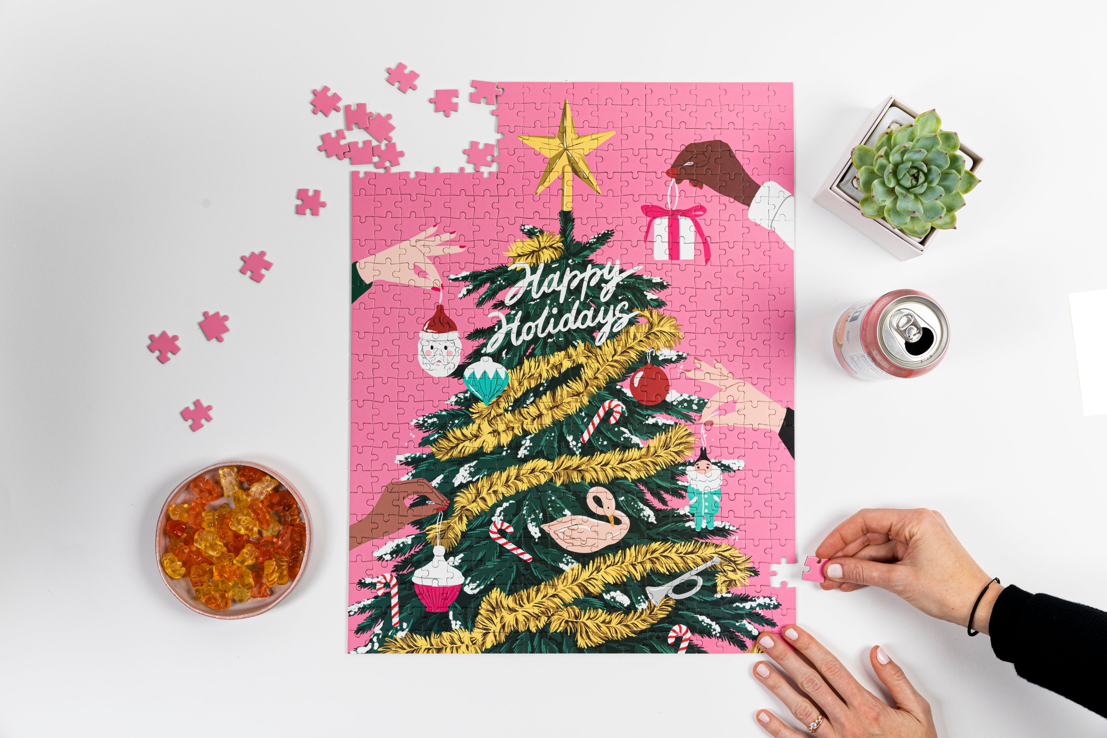 Near completed puzzle with a snack and a succulent