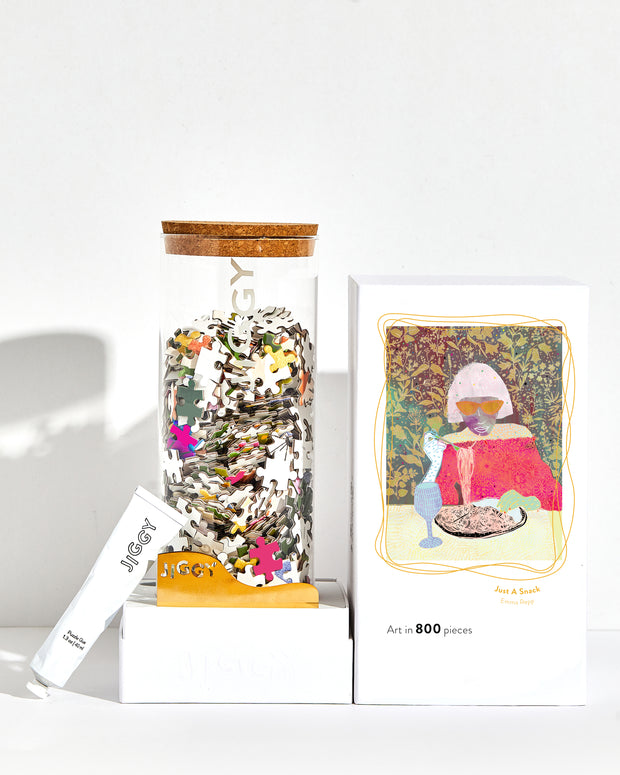 Just a Snack artwork puzzle box with reusable glass jar, tube of puzzle glue and straight-edge tool to spread the glue.