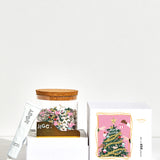 Tinsel Time Puzzle box with reusable glass jar, tube of puzzle glue and straight-edge tool to spread the glue.