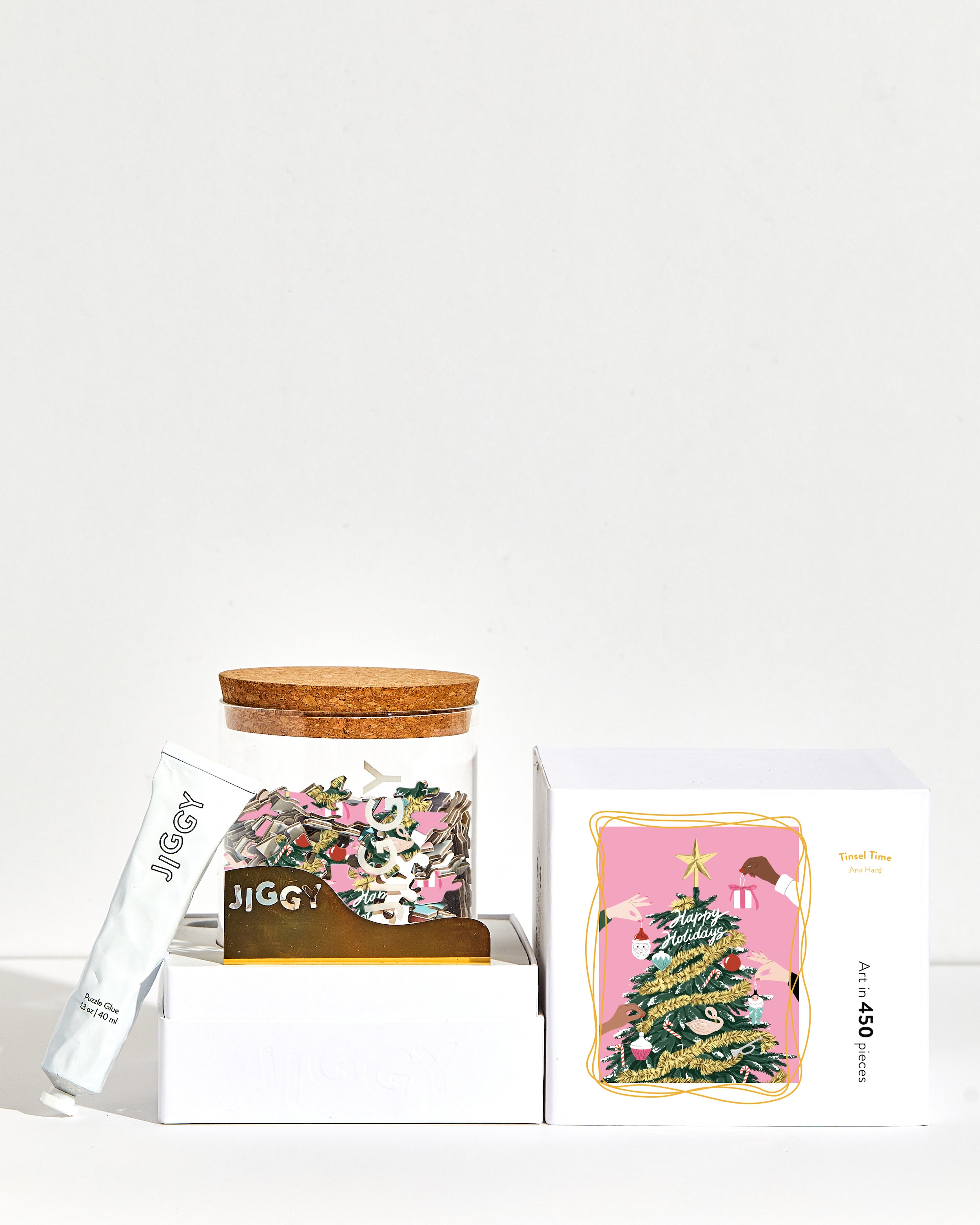 Tinsel Time Puzzle box with reusable glass jar, tube of puzzle glue and straight-edge tool to spread the glue.